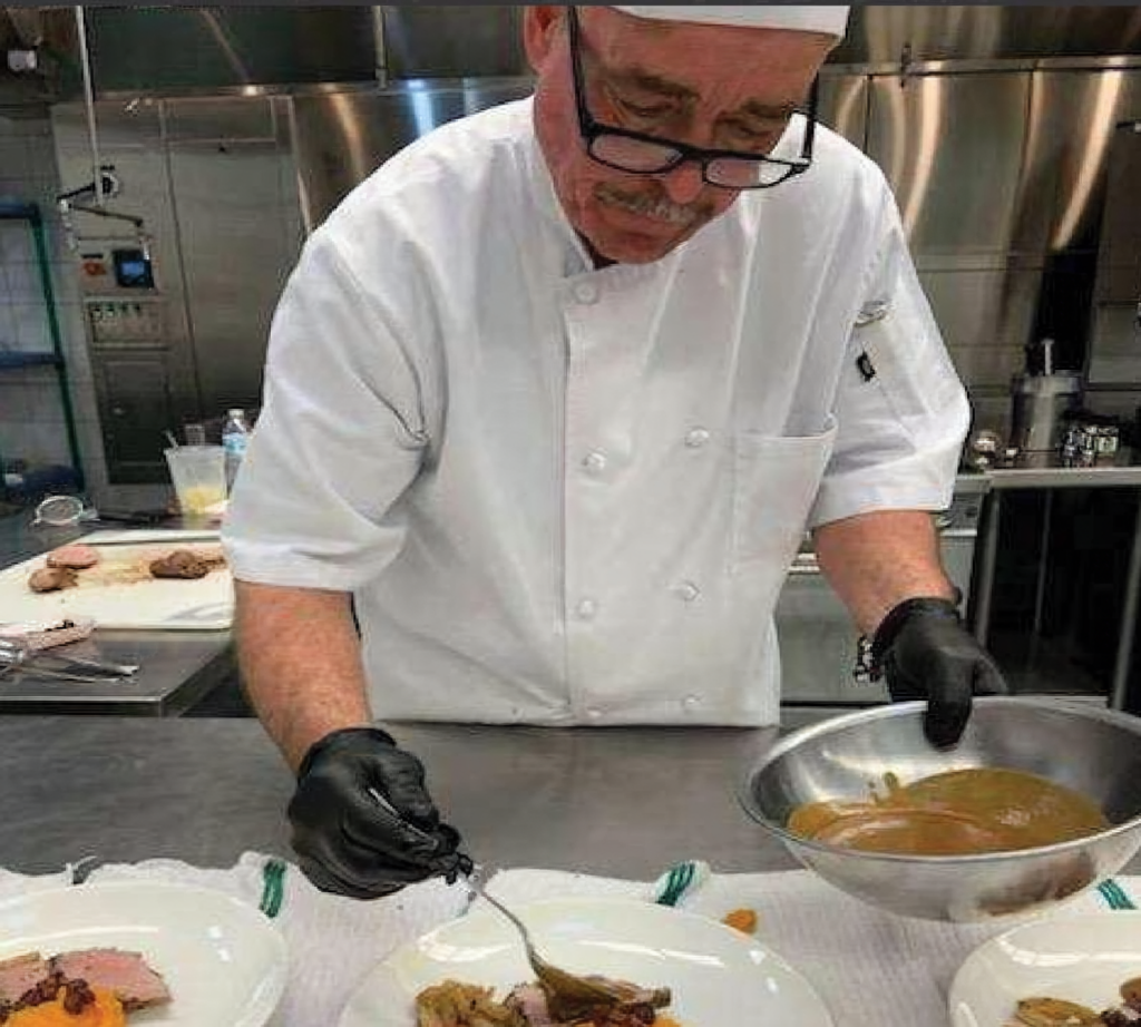 Chef Joe plating food.